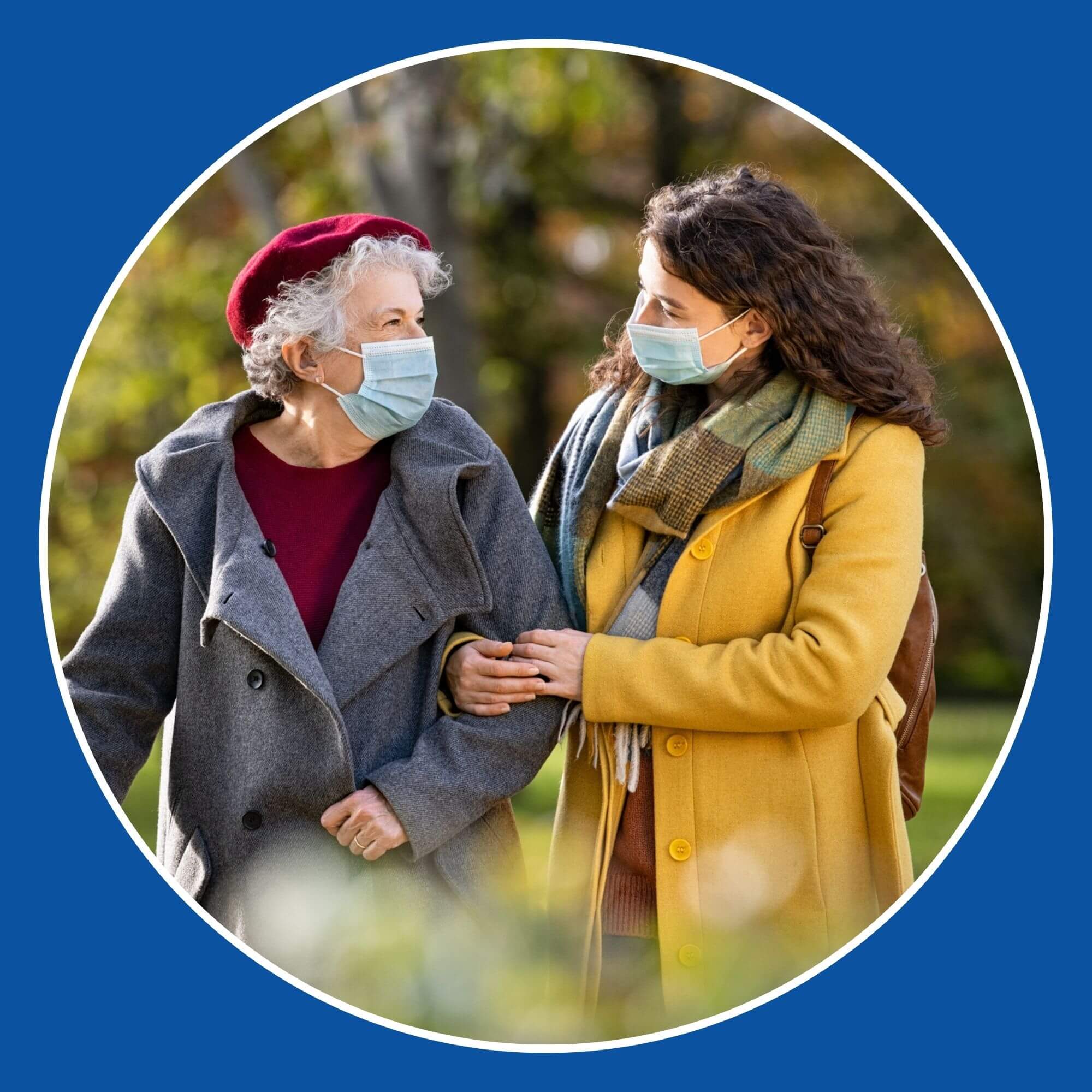 Photo showing an elderly lady walking through the park helped by a younger lady. Photo from iStock-1284869697