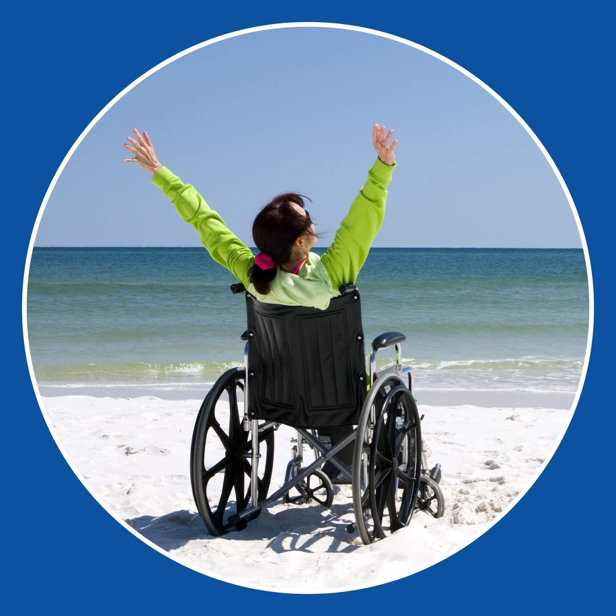Photo showing a happy woman in a wheelchair on a beach with arms in the air. Image from Photodune-4623801
